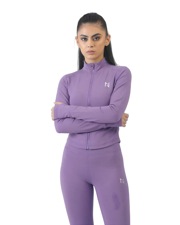 Woman wearing a purple athletic outfit with a logo on a white background