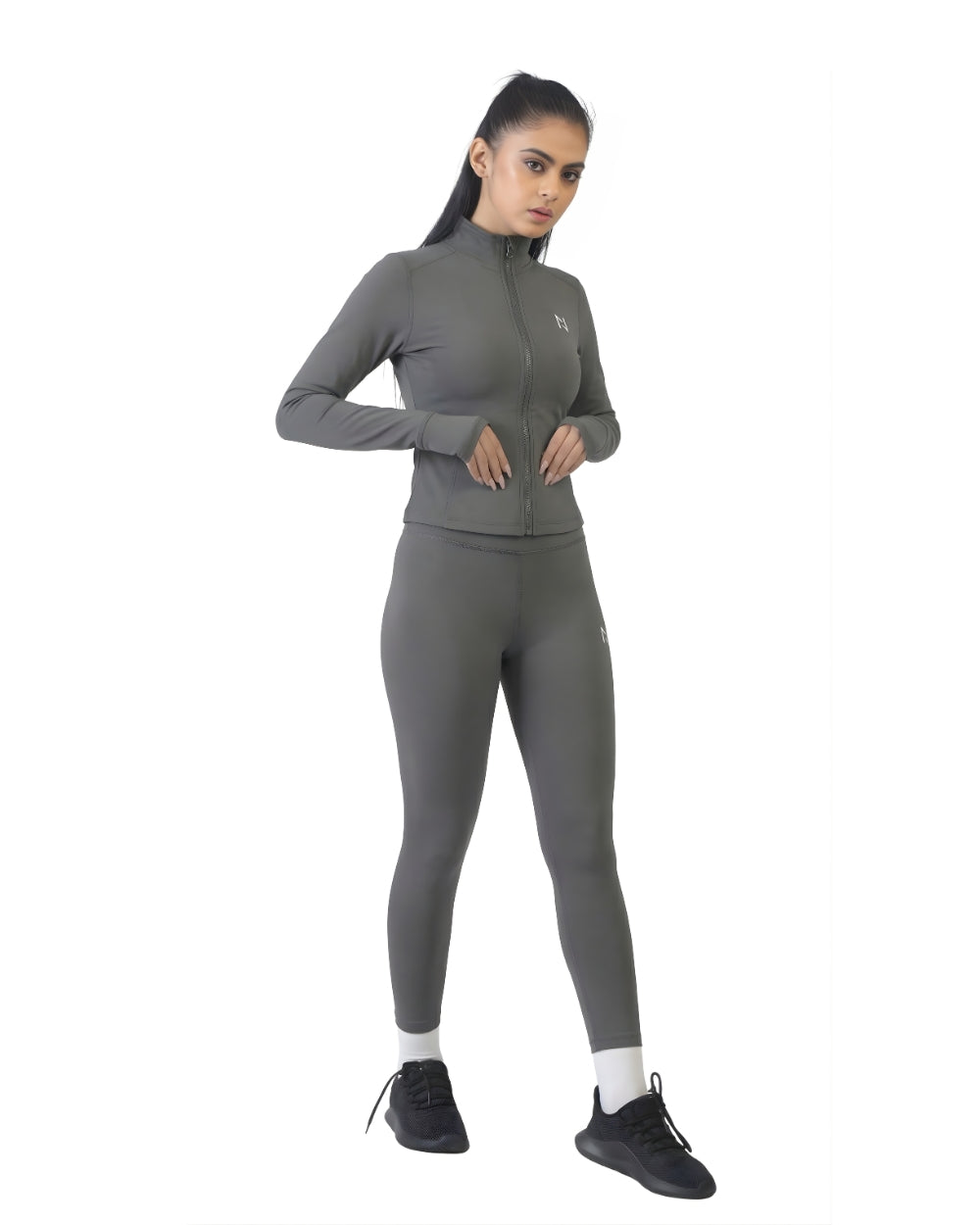 Woman wearing a gray athletic outfit on a white background