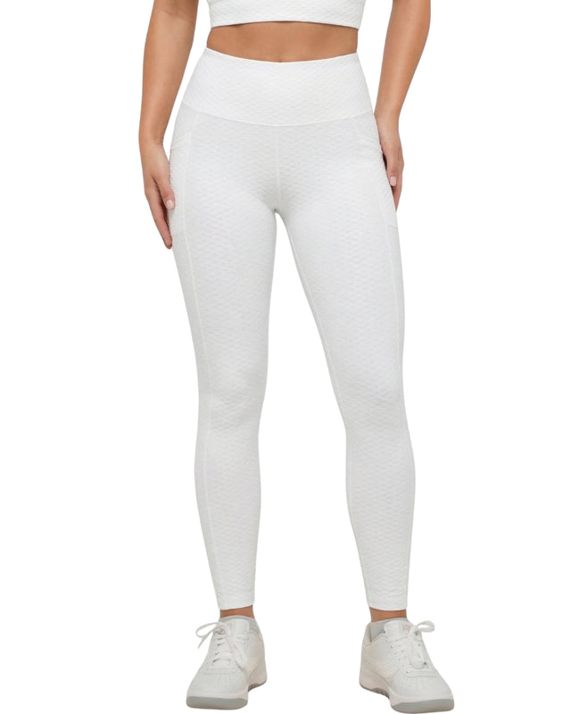 Person wearing white leggings and a white top on a white background