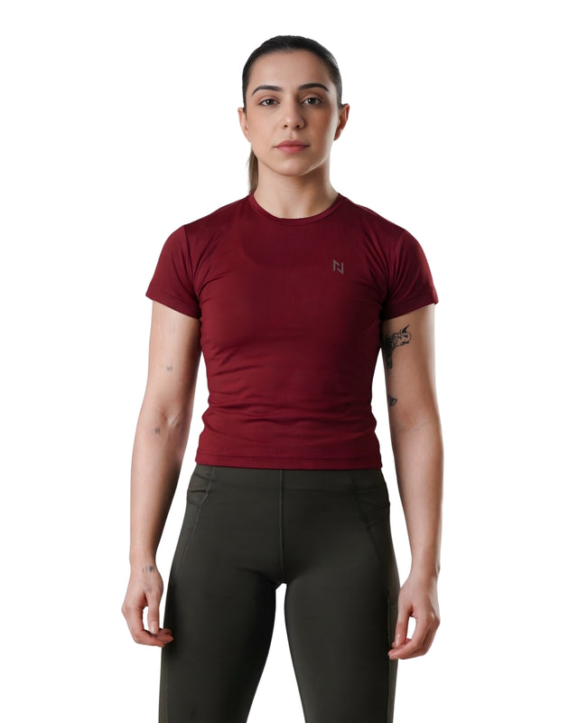 Person wearing a red t-shirt and dark pants on a white background