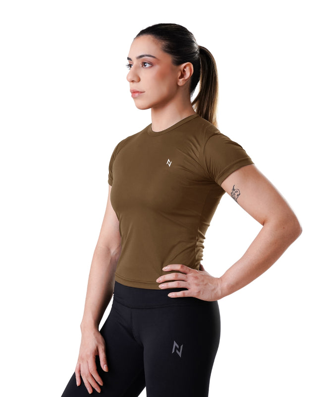 Woman wearing a brown athletic shirt and black leggings with a logo on a white background