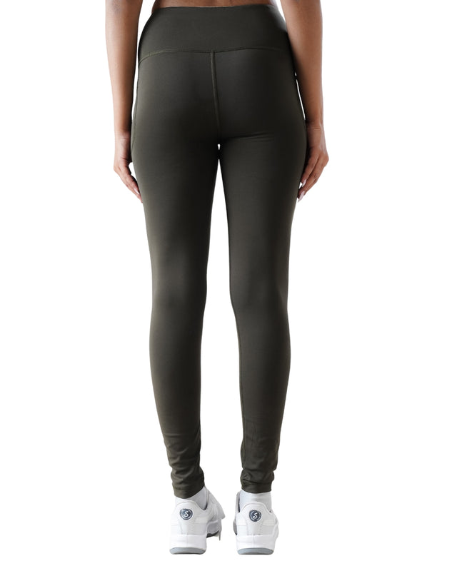 Person wearing dark green leggings on a white background