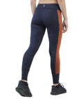 Navy leggings with orange stripe worn by a person on a white background