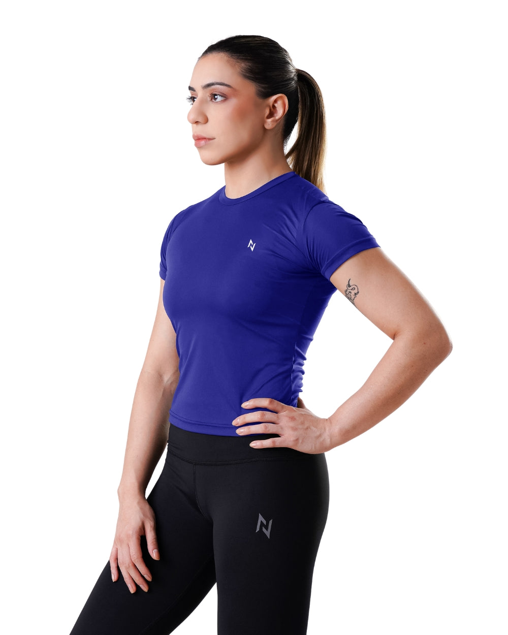 Woman wearing a blue athletic shirt and black leggings with a logo on a white background