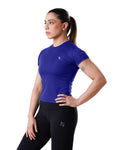 Woman wearing a blue athletic shirt and black leggings with a logo on a white background